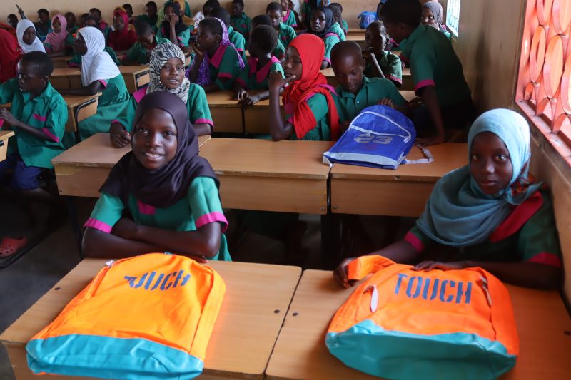 Happy students with their new school bags